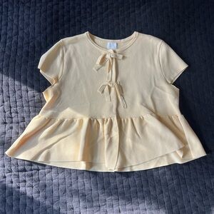 Charming Yellow Peplum Top with Bow Accents